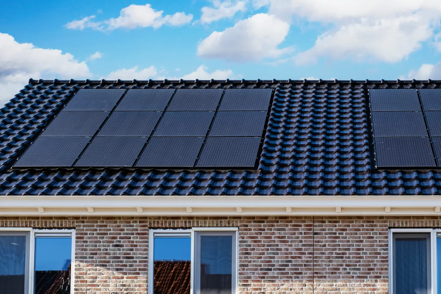 Solar Panel Installation & Roofing Services A close-up of sleek black solar panels installed on a dark tiled roof